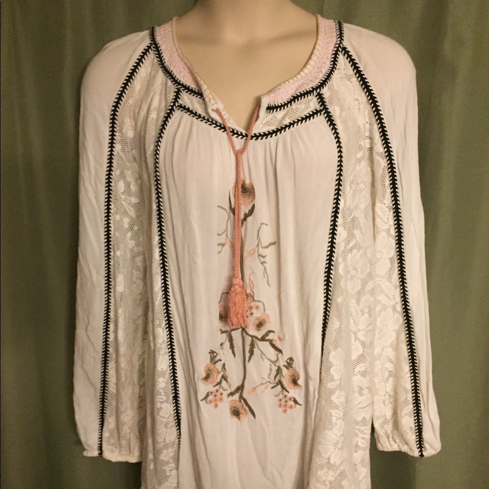 Baby doll blouse with embroidered flower print.